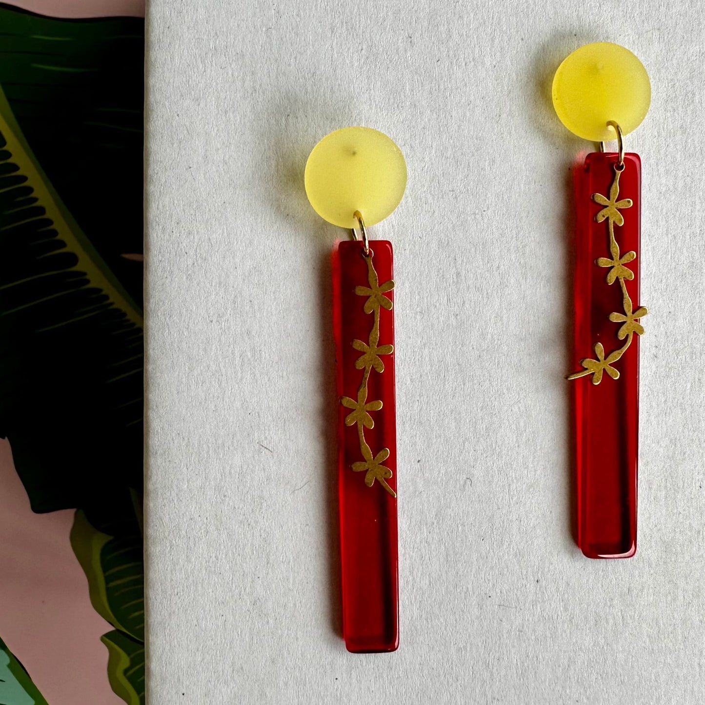 red dangle with gold flower trail and yellow posts