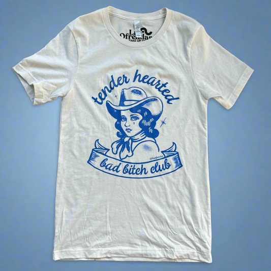 tender hearted bad bitches club print in blue on a natural colored t shirt